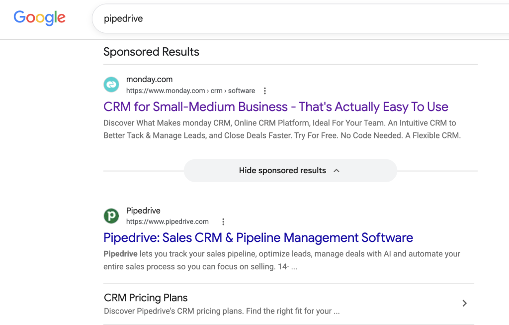 Screenshot of a Google search for Pipedrive showing an example of brand bidding where their direct competitor appears above them in search.